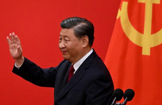 China's President Xi Jinping waves after introducing the members of the Chinese Communist Party's new Politburo Standing Committee, the nation's top decision-making body, in the Great Hall of the People in Beijing on October 23, 2022. (Photo by Noel Celis / AFP) (Photo by NOEL CELIS/AFP via Getty Images)